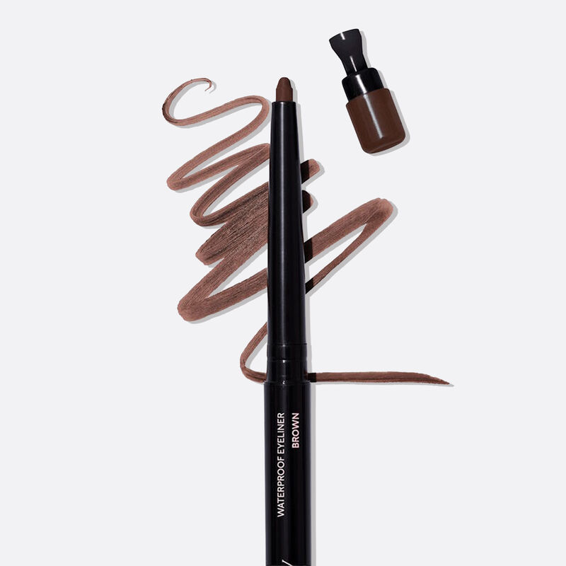 Uncapped Mary Kay Waterproof Eyeliner in Brown against color smudge background